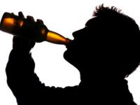 Man drinking bottle of cider silhouette